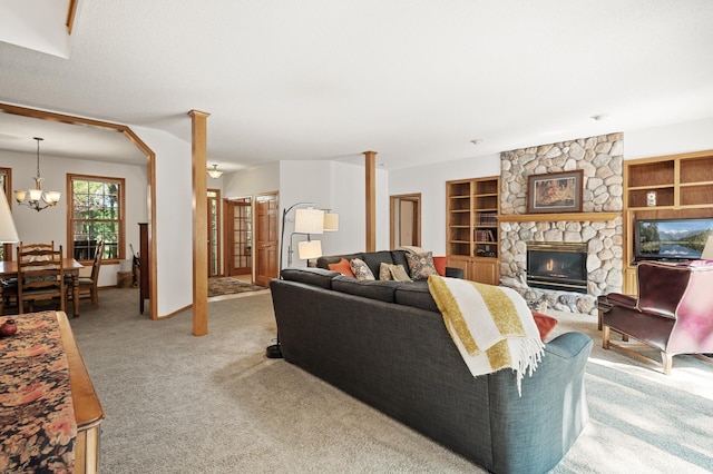 11691 115th St N, Grant, MN 55082 - living area with a chandelier, light colored carpet, a stone fireplace, and built in shelves