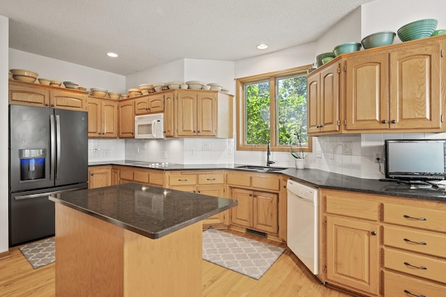 11691 115th St N, Grant, MN 55082 - kitchen with white appliances, light wood finished floors, a textured ceiling, a center island, and backsplash