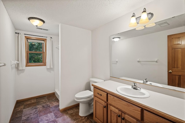 11691 115th St N, Grant, MN 55082 - bathroom with vanity, a textured ceiling, a shower, and stone finish floors