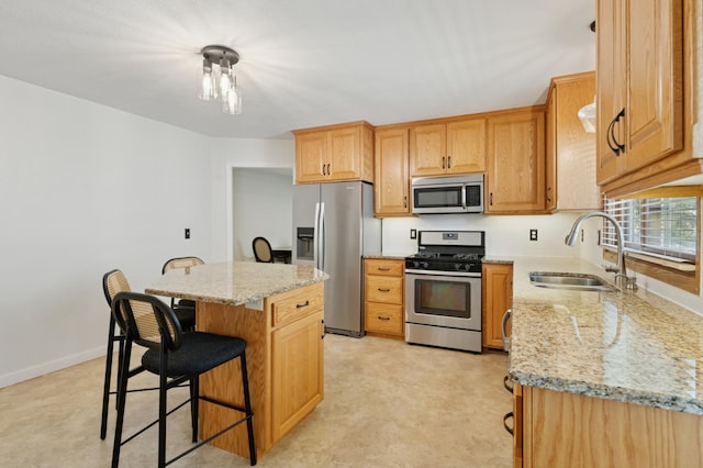 5737 20th Ave S, Minneapolis, MN 55417 - kitchen with stainless steel appliances, a breakfast bar area, a kitchen island, and light stone counters