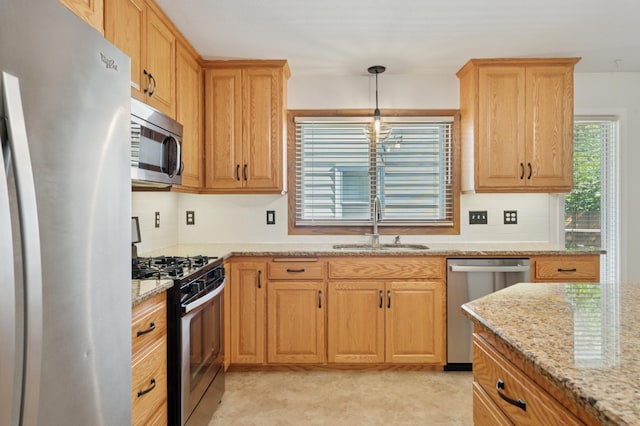 5737 20th Ave S, Minneapolis, MN 55417 - kitchen with appliances with stainless steel finishes, light stone counters, pendant lighting, and tasteful backsplash