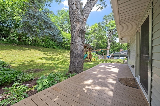 1762 Canyon Ln, New Brighton, MN 55112 - wooden deck featuring a playground, a yard, and view of wooded area