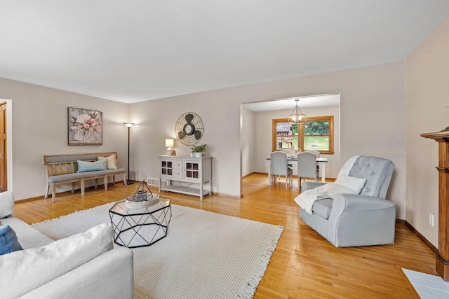 1762 Canyon Ln, New Brighton, MN 55112 - living room featuring light wood-style flooring and a chandelier