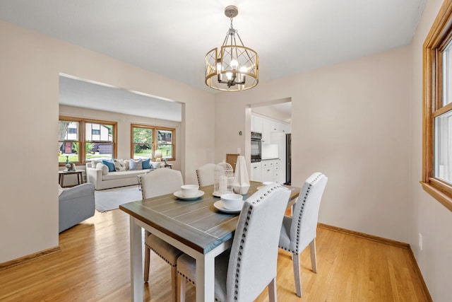 1762 Canyon Ln, New Brighton, MN 55112 - dining room featuring a chandelier and light wood-type flooring