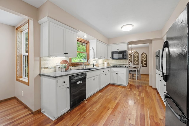 1762 Canyon Ln, New Brighton, MN 55112 - kitchen with black appliances, light wood-style floors, white cabinetry, decorative backsplash, and light stone countertops