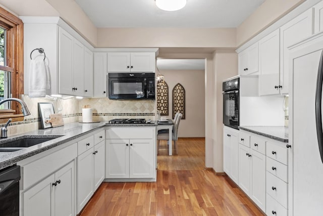 1762 Canyon Ln, New Brighton, MN 55112 - kitchen featuring black appliances, backsplash, white cabinets, and light stone counters