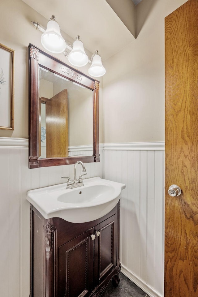 1762 Canyon Ln, New Brighton, MN 55112 - bathroom featuring a wainscoted wall, vanity, and a decorative wall