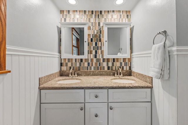 1762 Canyon Ln, New Brighton, MN 55112 - full bath with double vanity, a wainscoted wall, and a decorative wall