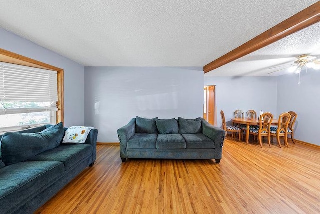 2813 Ohenry Rd, Brooklyn Center, MN 55430 - living room featuring light wood-type flooring, a textured ceiling, and ceiling fan
