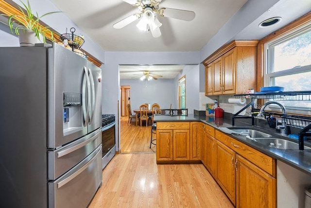 2813 Ohenry Rd, Brooklyn Center, MN 55430 - kitchen with appliances with stainless steel finishes, a ceiling fan, and brown cabinetry