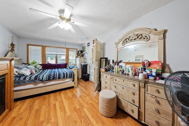 2813 Ohenry Rd, Brooklyn Center, MN 55430 - bedroom featuring a textured ceiling, light wood finished floors, and ceiling fan