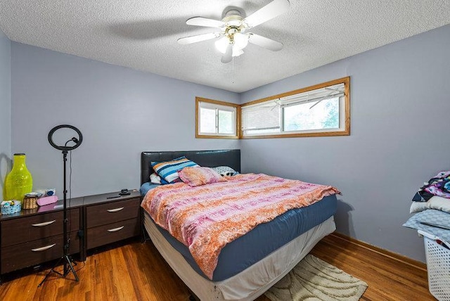 2813 Ohenry Rd, Brooklyn Center, MN 55430 - bedroom featuring a textured ceiling, wood finished floors, and ceiling fan