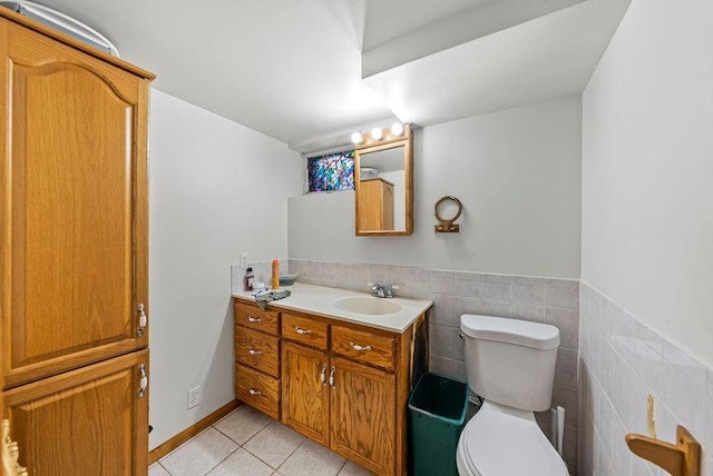 2813 Ohenry Rd, Brooklyn Center, MN 55430 - bathroom featuring vanity, tile patterned flooring, tile walls, and a wainscoted wall