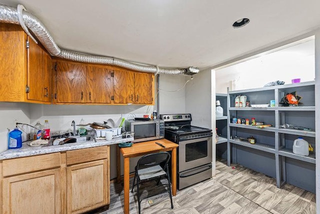 2813 Ohenry Rd, Brooklyn Center, MN 55430 - kitchen with stainless steel appliances, light countertops, light floors, and brown cabinetry