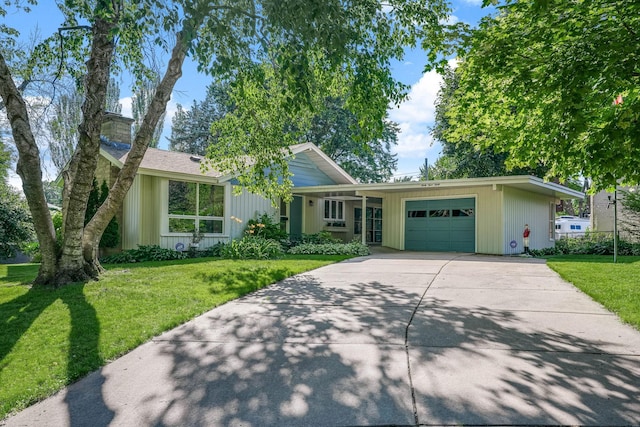 3330 Belden Dr NE, Saint Anthony, MN 55418 - view of front of house with an attached garage, a front yard, and concrete driveway