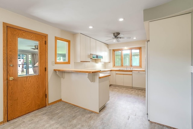 3330 Belden Dr NE, Saint Anthony, MN 55418 - kitchen featuring white dishwasher, a ceiling fan, a peninsula, white cabinetry, and recessed lighting