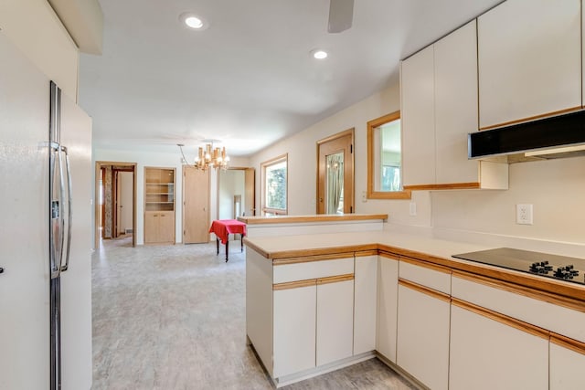 3330 Belden Dr NE, Saint Anthony, MN 55418 - kitchen featuring freestanding refrigerator, a peninsula, a chandelier, black electric cooktop, and light countertops