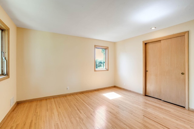 3330 Belden Dr NE, Saint Anthony, MN 55418 - unfurnished bedroom featuring light wood-style floors and a closet