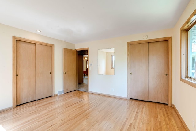 3330 Belden Dr NE, Saint Anthony, MN 55418 - unfurnished bedroom with light wood-style floors and recessed lighting