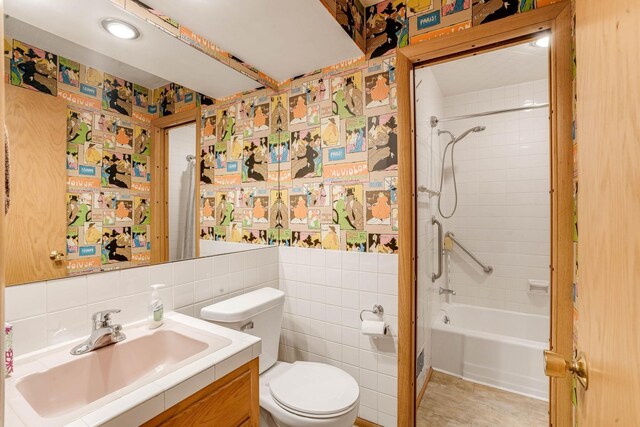 3330 Belden Dr NE, Saint Anthony, MN 55418 - bathroom featuring vanity, tile walls,  shower combination, and wallpapered walls