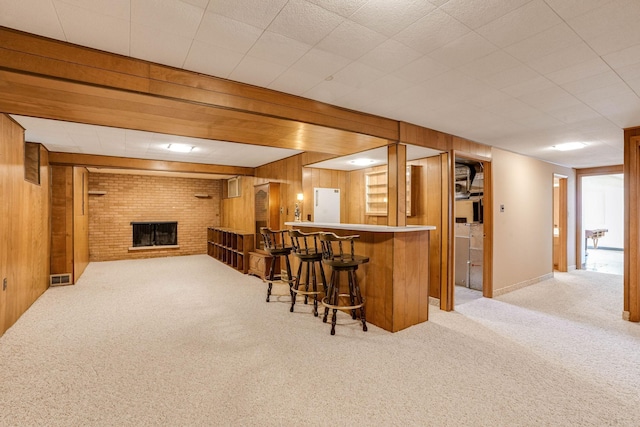 3330 Belden Dr NE, Saint Anthony, MN 55418 - indoor dry bar with carpet floors, wood walls, and a brick fireplace
