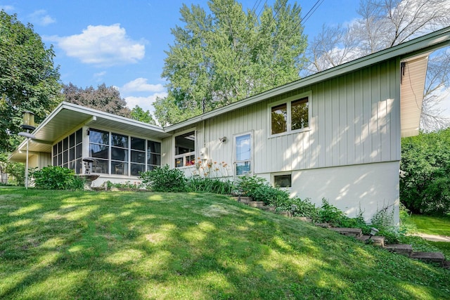3330 Belden Dr NE, Saint Anthony, MN 55418 - back of house featuring a lawn and a sunroom