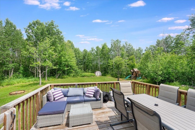4179 W Tischer Rd, Rice Lake, MN 55803 - wooden terrace with outdoor dining area, an outdoor living space, a playground, and a lawn