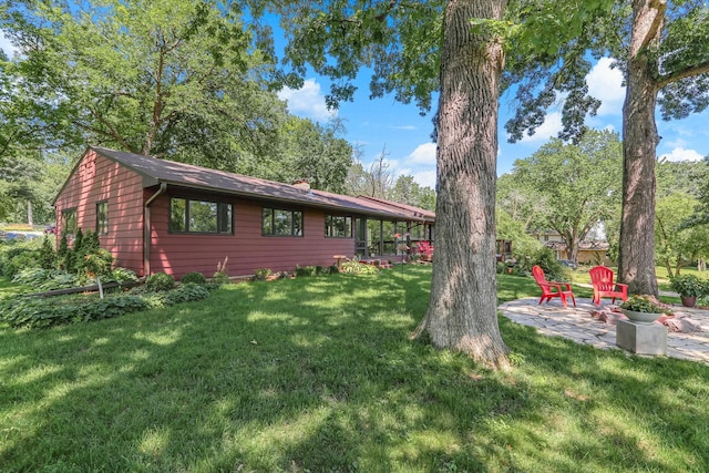 789 Viking Dr E, Little Canada, MN 55117 - view of front of house featuring a patio, a front lawn, and a chimney