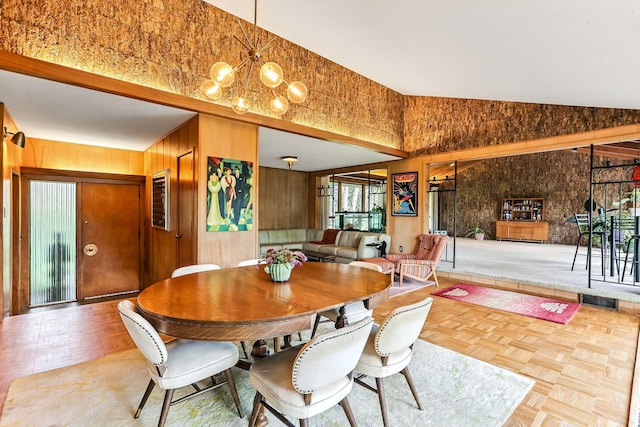 789 Viking Dr E, Little Canada, MN 55117 - dining area featuring wood walls, high vaulted ceiling, and a chandelier