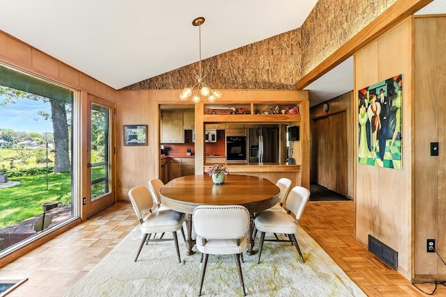 789 Viking Dr E, Little Canada, MN 55117 - dining area featuring lofted ceiling, wood walls, and a chandelier