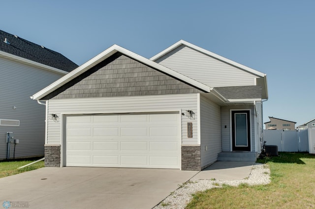 7339 24th St S, Fargo, ND 58104 - craftsman-style home with stone siding, an attached garage, and driveway