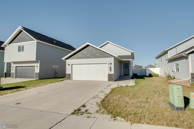 7339 24th St S, Fargo, ND 58104 - craftsman inspired home with concrete driveway, a garage, and stone siding