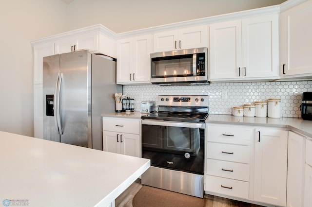 7339 24th St S, Fargo, ND 58104 - kitchen featuring appliances with stainless steel finishes, light countertops, white cabinetry, and backsplash