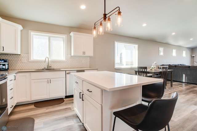 7339 24th St S, Fargo, ND 58104 - kitchen with backsplash, light wood finished floors, appliances with stainless steel finishes, and recessed lighting