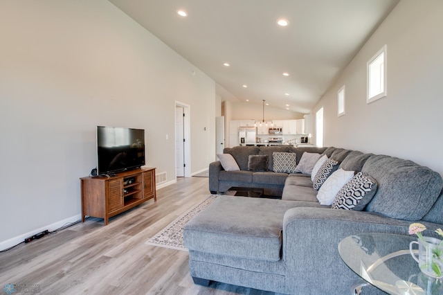 7339 24th St S, Fargo, ND 58104 - living room with recessed lighting, light wood-type flooring, and lofted ceiling