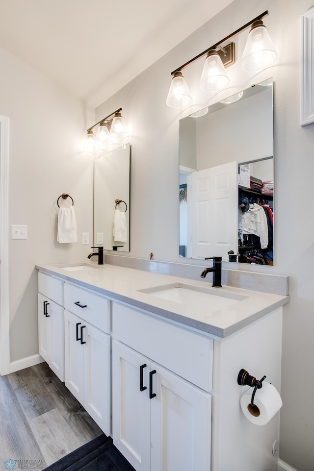 7339 24th St S, Fargo, ND 58104 - bathroom featuring double vanity and wood finished floors
