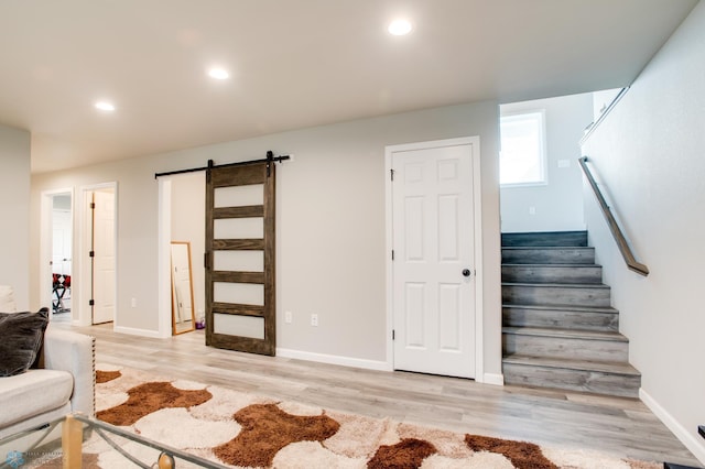 7339 24th St S, Fargo, ND 58104 - staircase featuring a barn door, wood finished floors, and recessed lighting