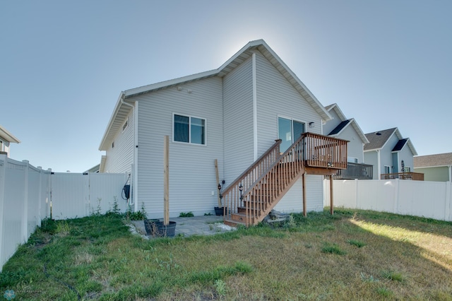 7339 24th St S, Fargo, ND 58104 - rear view of property with a fenced backyard, a wooden deck, and stairs