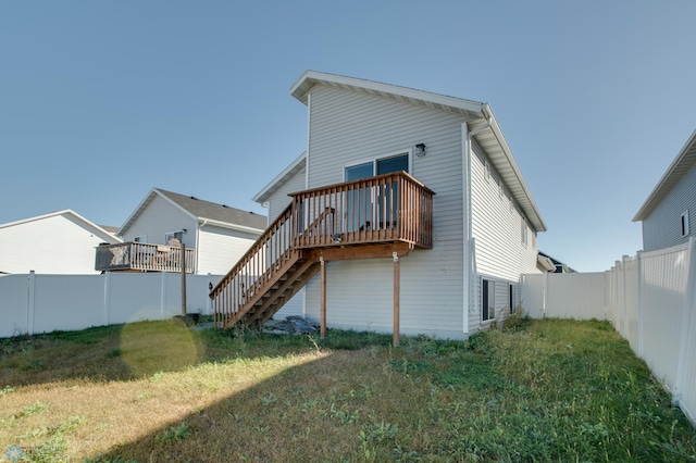 7339 24th St S, Fargo, ND 58104 - back of property featuring stairway, a fenced backyard, and a wooden deck