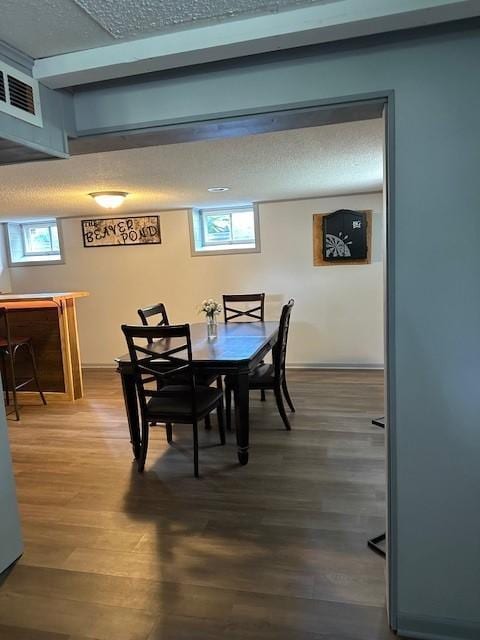 5025 Wilshire Blvd, Crystal, MN 55429 - dining space with wood finished floors, a dry bar, and a textured ceiling