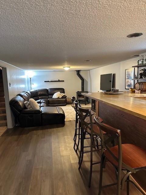 5025 Wilshire Blvd, Crystal, MN 55429 - dining room featuring a textured ceiling, wood finished floors, stairway, and a dry bar