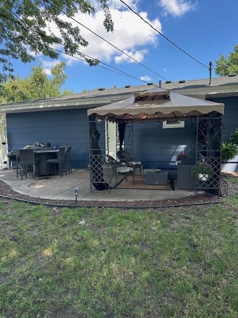 5025 Wilshire Blvd, Crystal, MN 55429 - back of house featuring a patio area, an outdoor living space, and a lawn