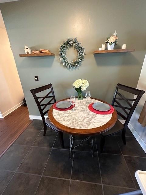 5025 Wilshire Blvd, Crystal, MN 55429 - dining room featuring dark tile patterned floors and baseboards