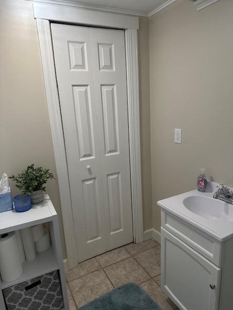5025 Wilshire Blvd, Crystal, MN 55429 - bathroom with vanity, tile patterned flooring, ornamental molding, and a closet
