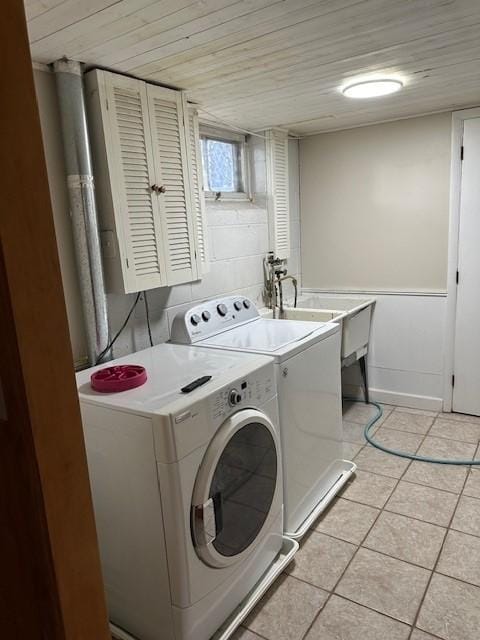 5025 Wilshire Blvd, Crystal, MN 55429 - laundry area featuring washing machine and clothes dryer, light tile patterned floors, and wood ceiling