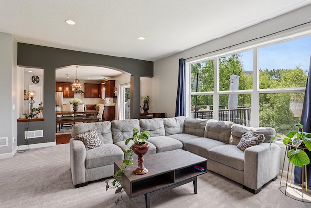 6287 Fountain Ln N, Maple Grove, MN 55311 - living room featuring arched walkways, light colored carpet, recessed lighting, and a chandelier