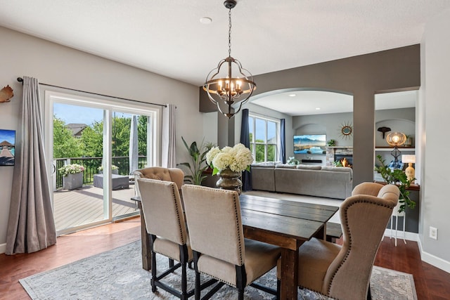 6287 Fountain Ln N, Maple Grove, MN 55311 - dining room with a chandelier, arched walkways, and wood finished floors