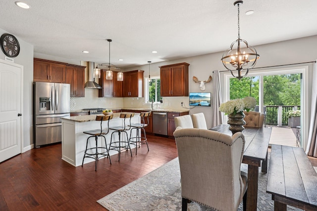 6287 Fountain Ln N, Maple Grove, MN 55311 - kitchen with appliances with stainless steel finishes, wall chimney range hood, dark wood finished floors, a center island, and recessed lighting