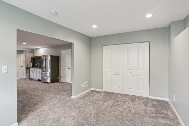 6287 Fountain Ln N, Maple Grove, MN 55311 - unfurnished bedroom featuring freestanding refrigerator, carpet flooring, a closet, and recessed lighting