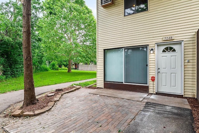 7248 72nd Ln N, Brooklyn Park, MN 55428 - view of exterior entry with a yard and a patio area